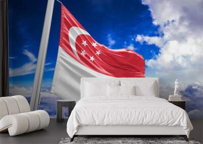 Singapore national flag cloth fabric waving on beautiful Blue Sky Background. Wall mural