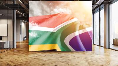 South Africa national flag cloth fabric waving on beautiful cloudy Background. Wall mural