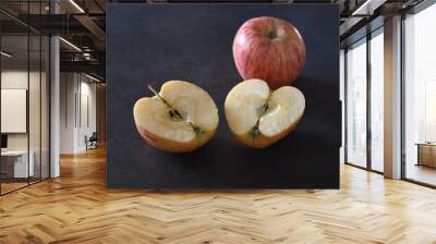 Apple cut in two halves and a full apple Wall mural