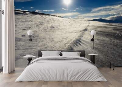 Sun and blowing snow on the Dalton Highway through the Brooks Range mountains Alaska Wall mural