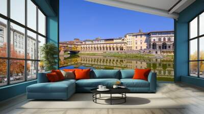 The famous Ponte Vecchio, the Old Bridge and city houses with reflections in the Arno River, Florence, Tuscany, Italy Wall mural