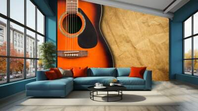 Acoustic guitar resting against a blank grunge background with c Wall mural