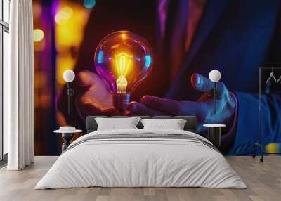 Businessman holding glowing light bulb in hand. Business and technology concept. Innovation creativity idea illuminated. Inspiration problem solution strategy. Entrepreneur brainstorming success. Wall mural