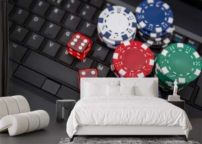 Colorful Poker Chips and Red Dice on Laptop Keyboard representing online gambling Wall mural