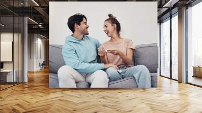 Pregnancy test, happy and couple in home living room, reading good news or check results. Kit, excited man and pregnant woman or mother smile on sofa for success, future maternity or ivf fertility Wall mural