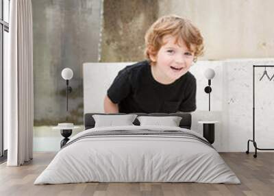 young boy laughing and playing Wall mural