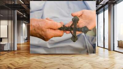 hand of grandmother and grandchild with the cross Wall mural