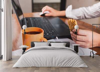 Home office with cereal bars and coffee.  Professional works from home with his laptop. Wall mural