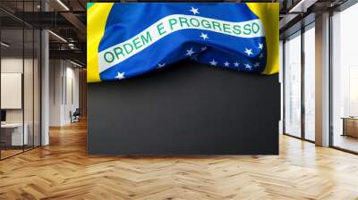 Brazilian flag lying on black grainy background Wall mural