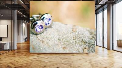 Silver cufflinks on white stone Wall mural