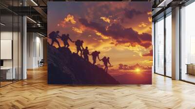 Group of hikers support each other on challenging mountain climb during sunset Wall mural