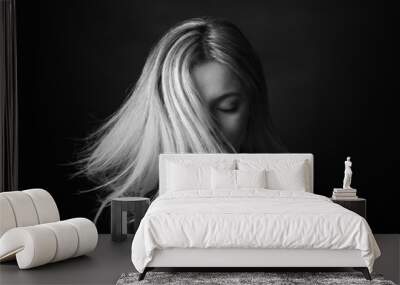 Dramatic black and white portrait of a beautiful woman on a dark background Wall mural