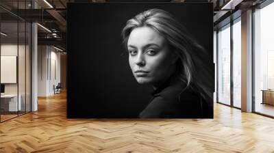 Dramatic black and white portrait of a beautiful woman on a dark background Wall mural