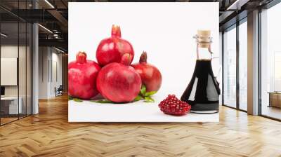 Grenadine in bottle and pomegranates on white background Wall mural