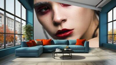 Young beautiful model with bright make up in red colours Wall mural