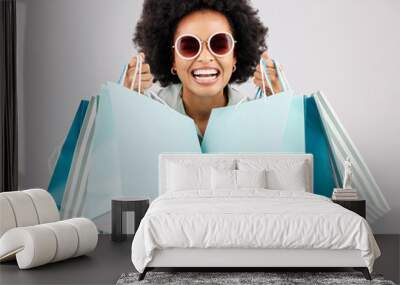 Portrait, shopping bags and black woman laughing with sunglasses in studio isolated on a white background. Sales deals, fashion and happiness of rich, funny and wealthy person with retail products. Wall mural