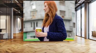 Young red woman with hot coffee Wall mural