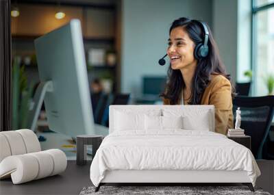 Indian Female Customer Support Representative Smiling While Assisting Clients on Computer Wall mural