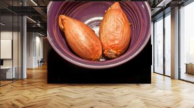 front view, close distance, of two freshly dug shallots in a purple, ceramic bowl Wall mural