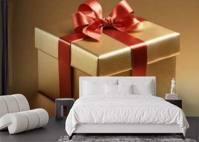 Gold gift box wrapped with a red ribbon and matching bow Wall mural