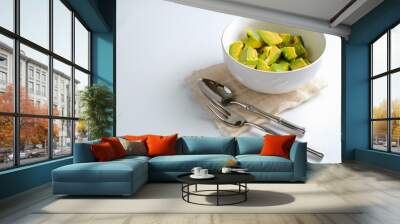 Fresh sliced avocado in white bowl Wall mural