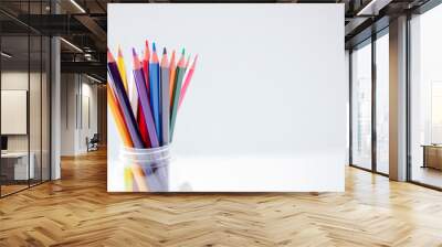 Multicolored pencils on white background Wall mural