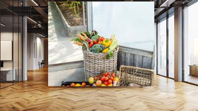 Baskets filled with freshly plucked vegetables and tomatoes on the organic farm Wall mural