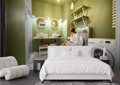 Beautiful loft interior bathroom with motion blurred woman in bathrobe sitting on the bowl Wall mural