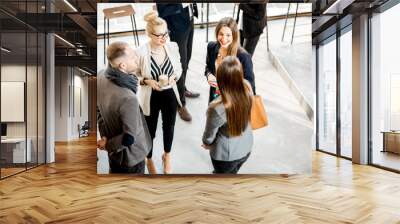 Business people having a conversation during the coffee break standing in the cafe Wall mural