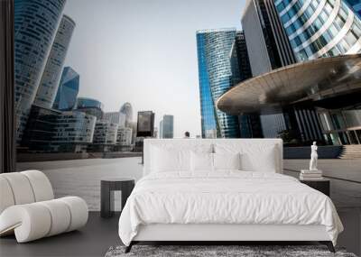 Business woman at the financial district with beautiful skyscrapers on the background during the morning light in Paris. Wide panoramic view Wall mural