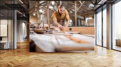 Carpenter working with a wood in the workshop Wall mural