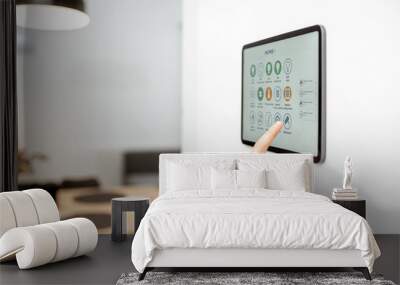 Controlling home with a digital touch screen panel installed on the wall. Close-up on a screen with mobile application for managing smart devices Wall mural