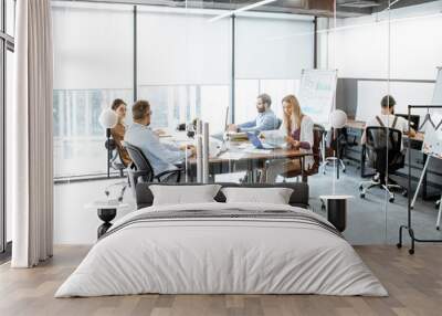 Group of diverse colleagues working on the computers in the modern office or coworking space, wide intreior view Wall mural