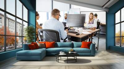 Group of diverse colleagues working on the computers in the modern office or coworking space, writing programming code Wall mural