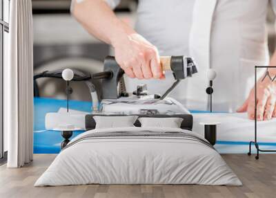 ironing a white shirt with professional iron in the laundry Wall mural