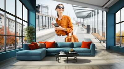 Portrait of a business woman at the transport stop Wall mural