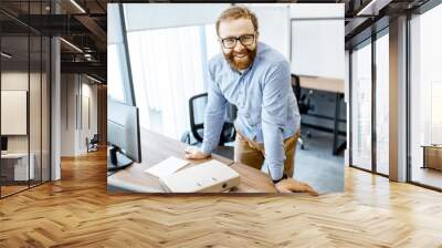 portrait of a handsome bearded office worker dressed casually during a work in the office Wall mural