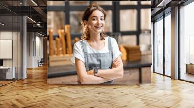 Portrait of a young and happy saleswoman at the counter in ice cream shop or cafe. Concept of a small business and retail Wall mural