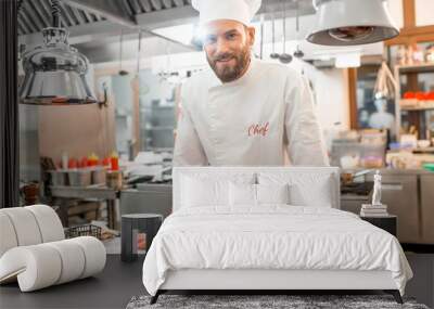 Portrait of chef cook in uniform with prepaired delicious dish at the restaurant kitchen Wall mural