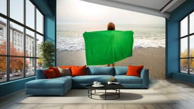 Woman in green towel on the beach Wall mural