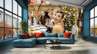 Woman with friends during a festive dinner on New Years Eve Wall mural