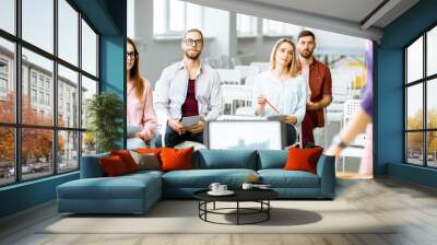 young business people dressed in casual clothes listening to the speaker in the conference hall duri Wall mural