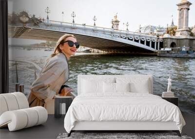 young woman enjoying beautiful landscape view on the riverside from the tourist ship during the suns Wall mural