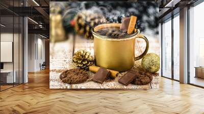 hot chocolate in golden copper mug, hot Christmas or winter drink with cinnamon, smoke or steam. Wall mural