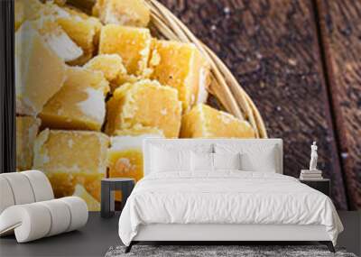 typical cane and molasses candy, made in brazil and latin america, inside a straw basket, typical latin american cuisine. Sweets typical of the June and July festivals. Wall mural