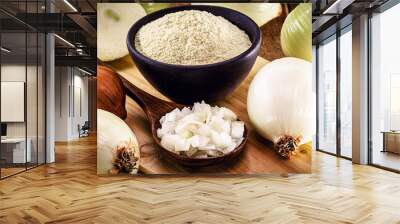 wooden spoon with sliced ​​onion and crushed into pieces to be used as seasoning, with powdered onion in the background, rustic kitchen Wall mural