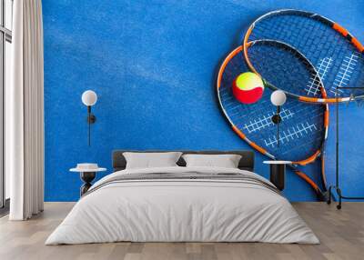 Children's Tennis ball and Tennis Rackets on blue background Wall mural