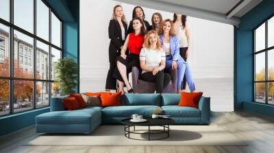 Happy women work team employees group looking at camera posing in studio, smiling women company staff workers, workforce members, business people managers standing together, portrait. Wall mural