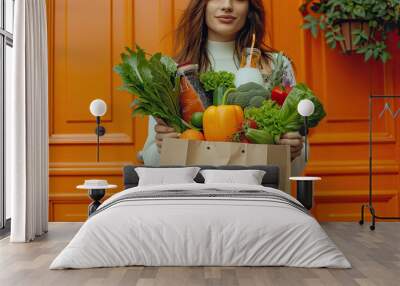 groceries, shopping healthy food. Portrait of cheerful beautiful Asian woman holding Paper Bag With Fresh Vegetables And Fruits at home Wall mural