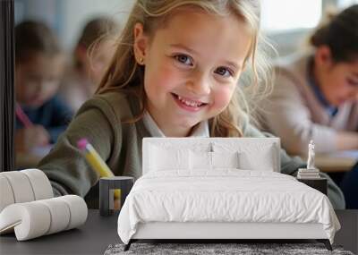 Schoolgirl writing while learning during a class in the classroom. Wall mural